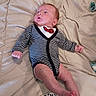 baby, newborn, child, infant, portrait, lying_down, bed, blanket, striped_clothing, cardigan, bow_tie, pacifier, face, eyes_open, indoor, bedroom, relaxed, cute, photography, furniture
