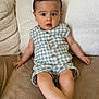 baby, casual, child, comfortable, couch, cozy, curious, expression, face, foot, furniture, hand, indoors, infant, plaid, romper, sitting, skin, soft, young