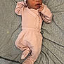 Reign is registered to the contest to win money with this photo: baby, infant, pink_clothing, headband, footies, blanket, gray_background, lying_down, cute, cozy, indoors, person, child, newborn, soft_fabric, sleepwear, baby_garment, portrait, resting, toddler