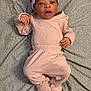 baby, infant, pink_clothing, headband, blanket, footwear, booties, bear_design, lying_down, cute, cozy, soft_textile, sleepwear, child, portrait, indoors, baby_girl, expression, small_hands, fabric