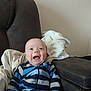 Asher joined the competition — help win amazing prizes! baby, child, smiling, happy, onesie, striped_clothing, blue_clothing, white_clothing, furniture, chair, blanket, indoor, person, infant, cute, portrait, cozy, seated, leather, home