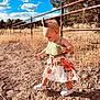 Nikkole is registered to the contest to win money with this photo: child, clouds, cute, daytime, dress, fence, floral_pattern, grass, headband, nature, outdoor, rocky_path, shoes, sky, summer, sunlight, toddler, tree, walking, young_child