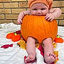 baby, pumpkin, orange_bonnet, fall_leaves, blanket, brick_wall, autumn, cute, infant, barefoot, seasonal, holiday, nature, outdoor, child, festive, small_pumpkins, playful, portrait, soft_texture