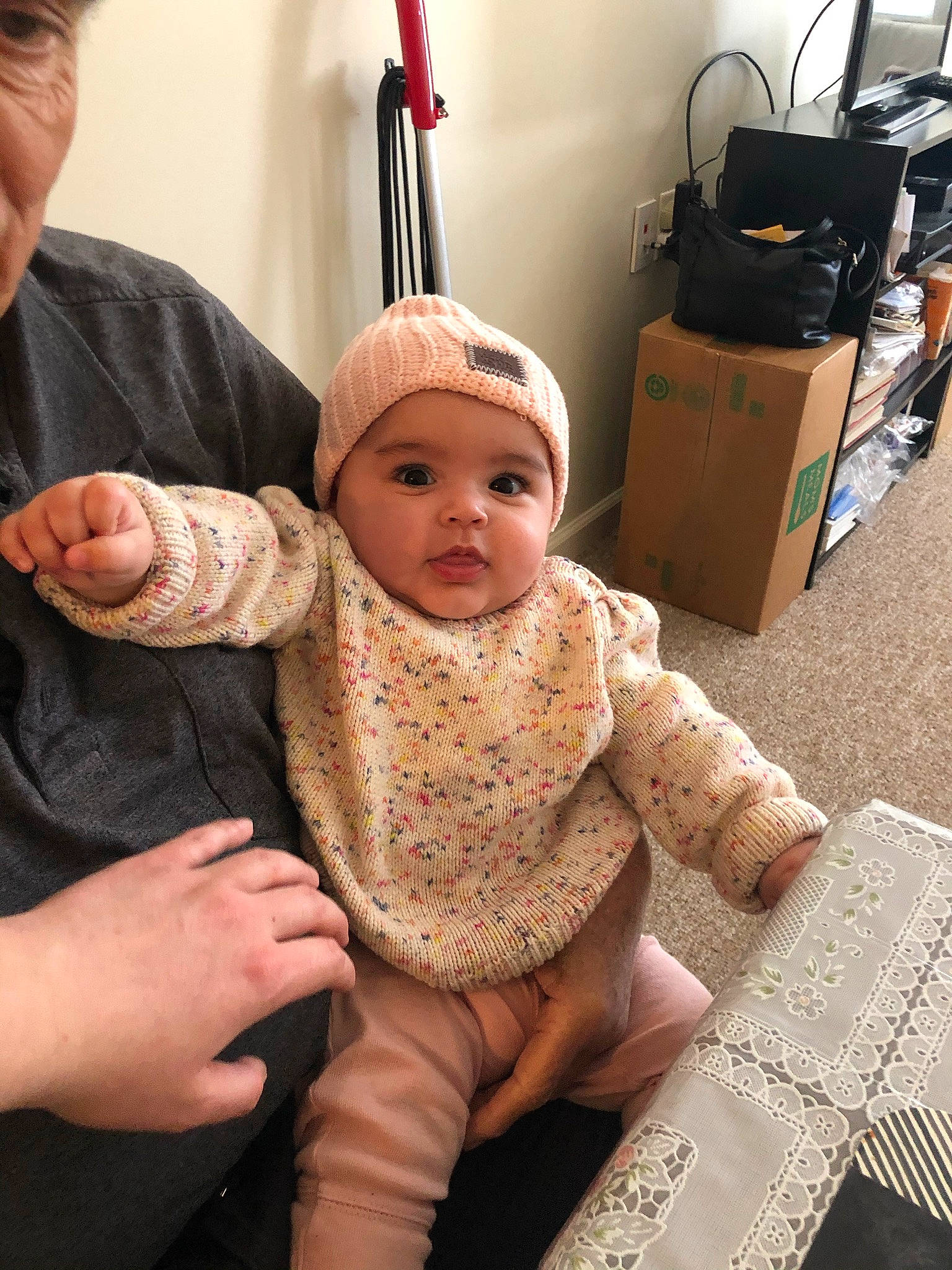 Kamilla is registered to the contest to win money with this photo: baby, baby_toddler_clothing, backpack, cap, chair, cheek, child, eye, face, gesture, hand, happy, head, headgear, headwear, luggage_and_bags, person, sitting, skin, sleeve