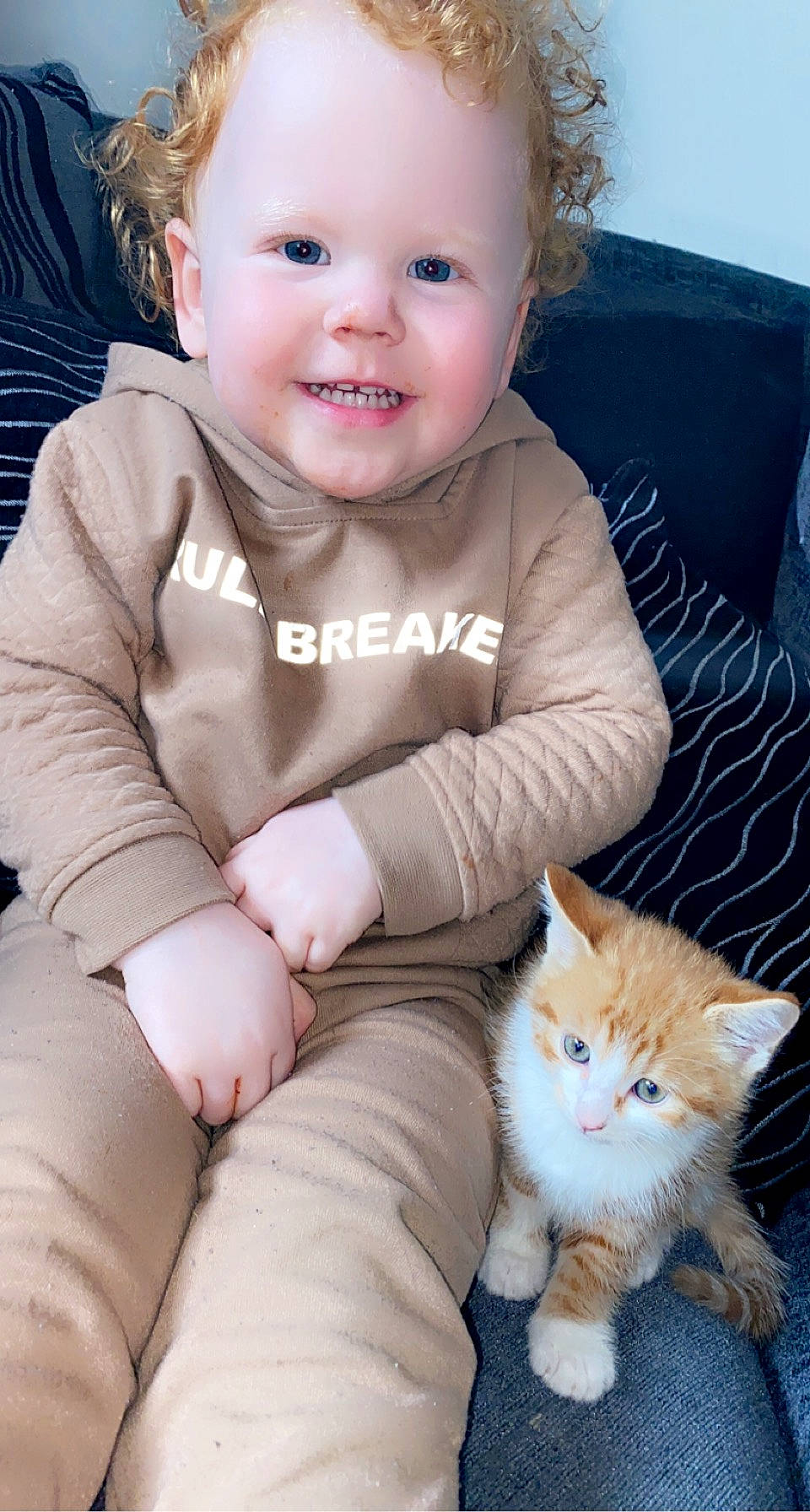 Arya Hopkins joined the competition — help win amazing prizes! baby, baby_toddler_clothing, blue, carnivore, cat, cheek, comfort, face, facial_expression, felidae, happy, iris, joy, lip, person, photograph, skin, sleeve, smile, textile