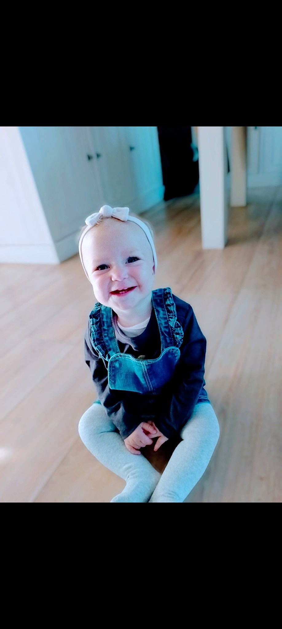 Hanaë participe au concours pour gagner de l'argent avec cette photo : baby, baby_toddler_clothing, child, dress, electric_blue, face, flash_photography, floor, flooring, fun, happy, hardwood, joy, pattern, person, sitting, sleeve, smile, standing, stock_photography