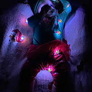 Oaklynn is registered to the contest to win money with this photo: baby, child, pajamas, lights, headband, bow, blanket, lying_down, indoor, soft_lighting, festive, holiday, red, green, footwear, cute, infant, cozy, toddler, smiling