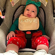 Oaklynn is registered to the contest to win money with this photo: baby, infant, car_seat, bib, headband, red_pants, white_shoes, smiling, cute, child, indoors, seatbelt, holiday_theme, happy, person, clothing, closeup, young_child, expression, baby_accessories