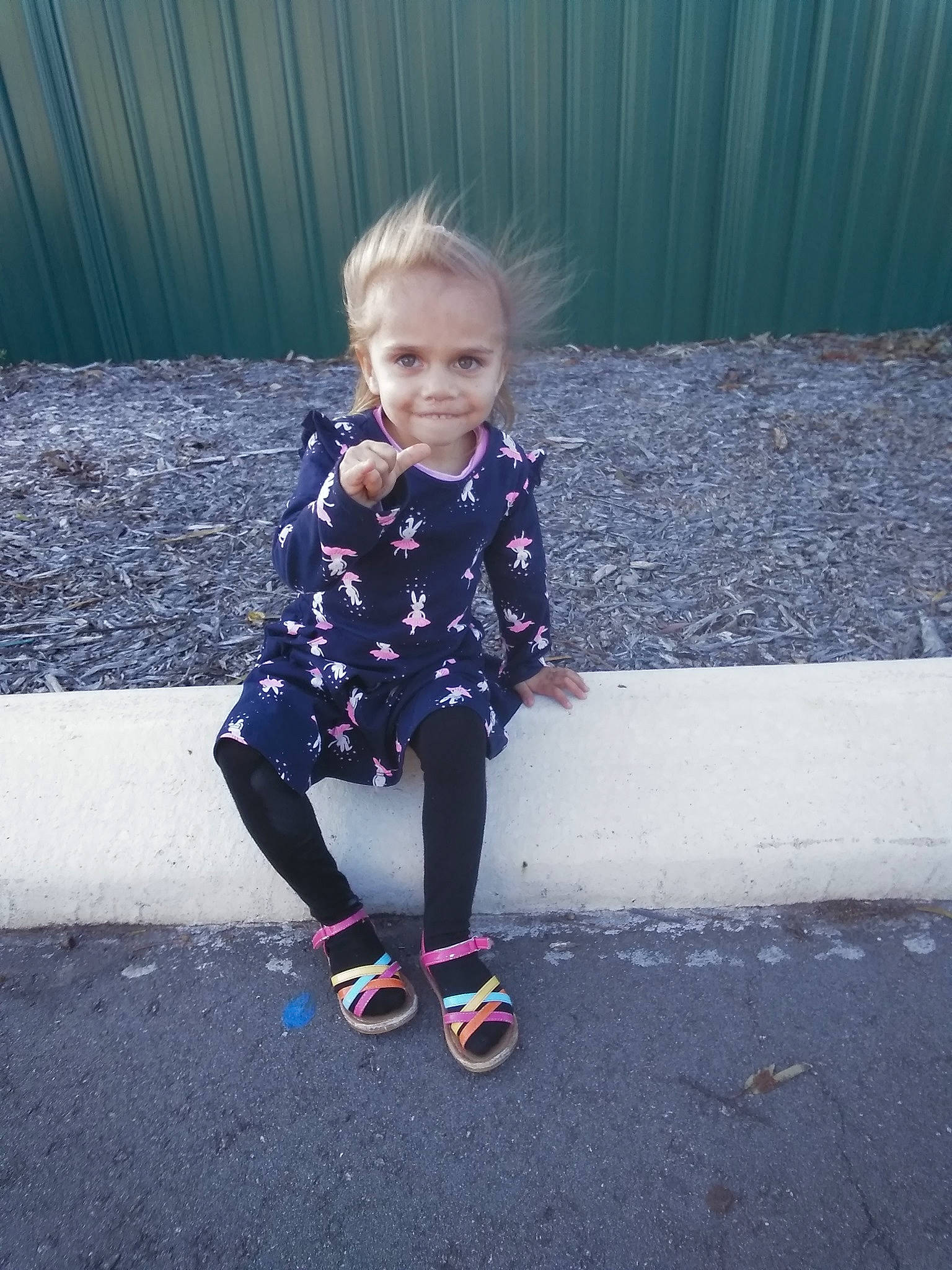 Darcy is registered to the contest to win money with this photo: asphalt, child, cool, footwear, grass, joy, outerwear, people, person, photography, plant, play, recreation, shoe, skin, smile, standing, toddler, vacation