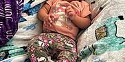 Jahmai is registered to the contest to win money with this photo: baby, child, smiling, blanket, colorful, patterned, pants, shirt, mushroom, floral, happy, indoor, chair, foot, cute, cozy, person, infant, relaxed, toddler