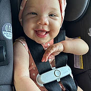 Laylani is registered to the contest to win money with this photo: baby, child, smiling, car_seat, seatbelt, polka_dot, hat, happy, infant, cute, safety, straps, closeup, skin, face, tongue, clothing, car, transportation, young