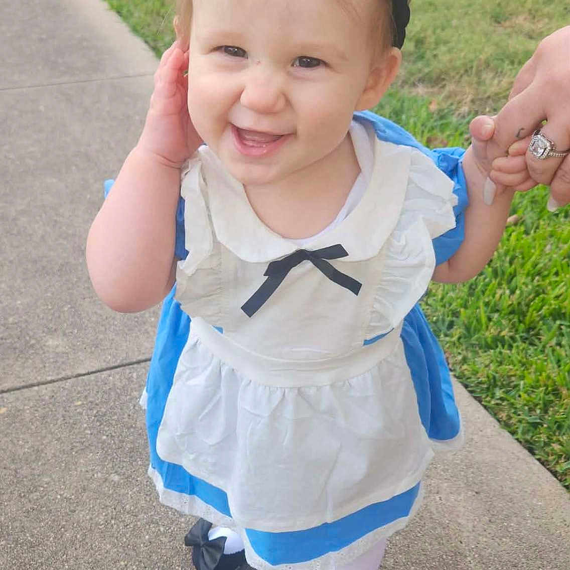 Alyena joined the competition — help win amazing prizes! black_bow, black_shoes, casual, child, cute, daylight, dress, grass, happy, headband, holding_hand, outdoor, person, portrait, sidewalk, smiling, toddler, walking, white_tights, young_child