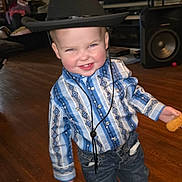 Wyatt joined the competition — help win amazing prizes! child, toddler, cowboy_hat, blue_shirt, jeans, smiling, indoor, wooden_floor, cookie, living_room, speaker, television, furniture, home, cute, portrait, person, happy, casual_clothing, playful