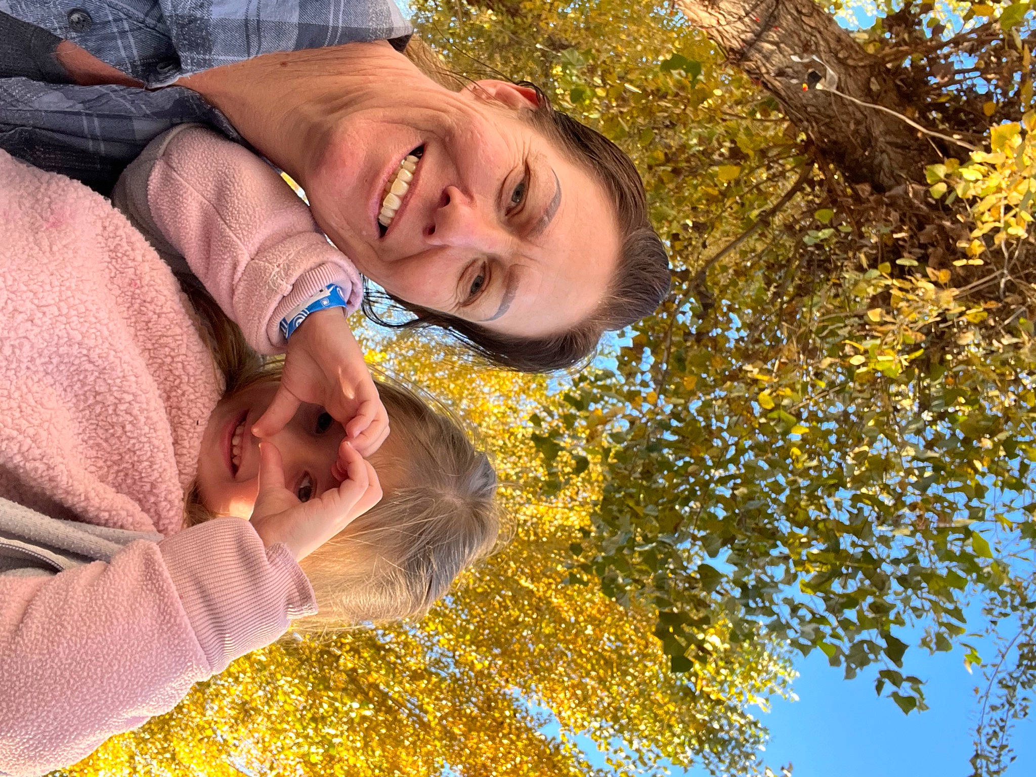 Quinn is registered to the contest to win money with this photo: autumn, fun, gesture, grass, happy, joy, laugh, leisure, people_in_nature, person, plant, portrait_photography, sky, smile, sunlight, tree, yellow