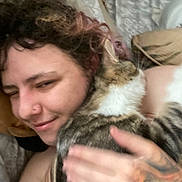 Anuket joined the competition — help win amazing prizes! person, cat, snuggling, bed, blanket, tattoo, curly_hair, nose_piercing, tabby_cat, indoor, close_up, affection, sleepy, hand, furry, warm, comfort, relaxation, intimacy, soft