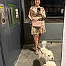 curly_fur, dog, dogs, dress, elevator, fashion, fluffy, handbag, indoor, leash, lobby, mirror_selfie, person, pink_harness, poodle, portrait, reflection, standing, white_dog, woman