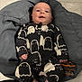 Flora joined the competition — help win amazing prizes! baby, barefoot, black, child, clothing, cozy, cushion, cute, floor, ghost_pattern, gray, happy, indoors, infant, onesie, person, portrait, small, smiling, white