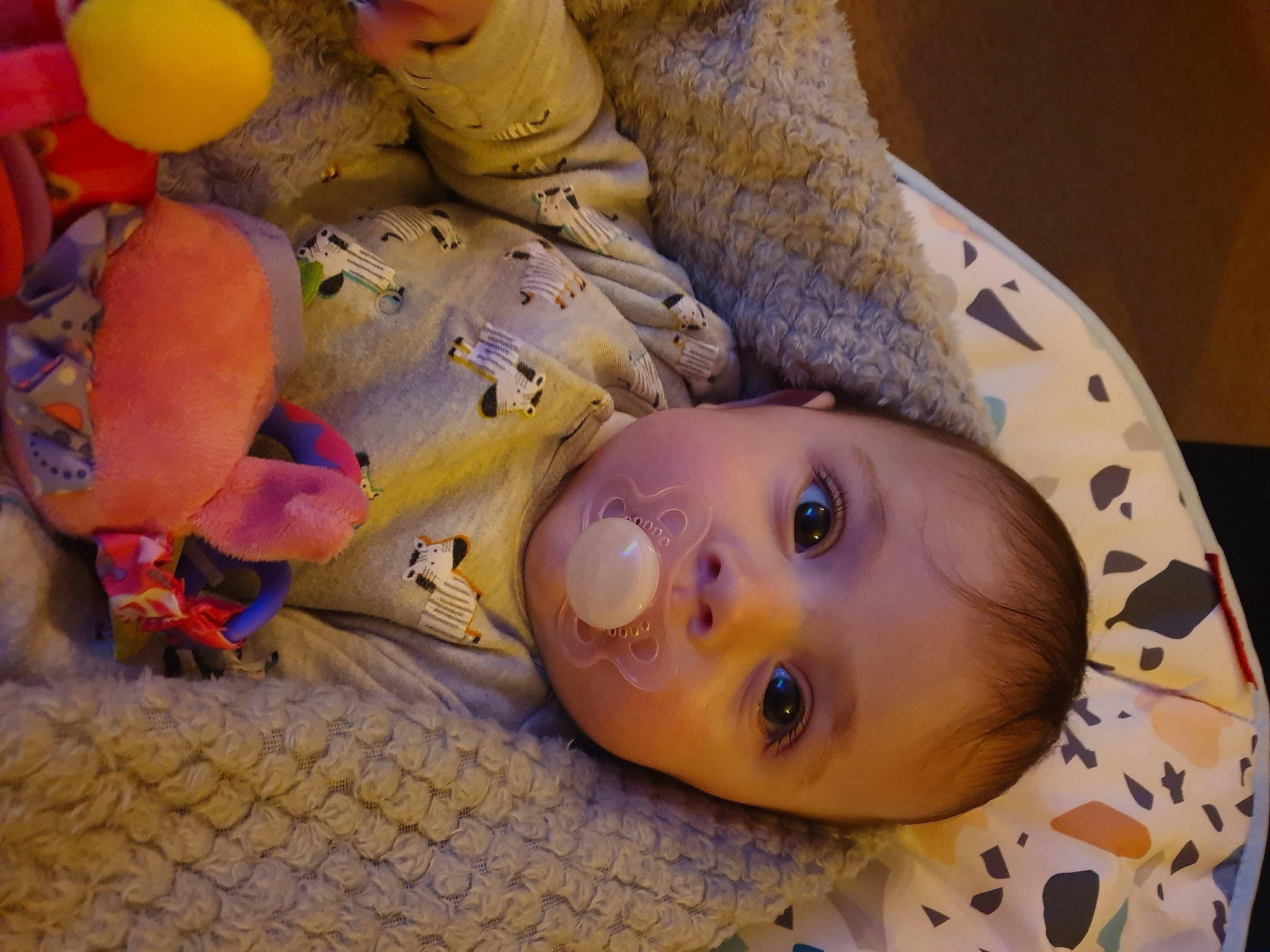 Sienna is registered to the contest to win money with this photo: baby, baby_products, baby_toddler_clothing, baby_toys, flooring, fur, happy, linens, mammal, pattern, person, plush, room, smile, stuffed_toy, toddler, toy, wood