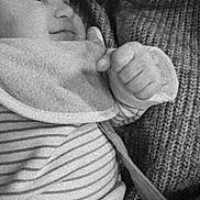 Gabin participe au concours pour gagner de l'argent avec cette photo : baby, infant, adult, black_and_white, close_up, smile, face, hand, sweater, knitwear, holding, love, heart_emoji, striped_clothing, cozy, portrait, cuddle, warmth, expression, bond
