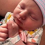 Maya is registered to the contest to win money with this photo: newborn, baby, sleeping, infant, hat, onesie, hospital_bracelet, tattoo, hand, closed_eyes, skin, closeup, person, peaceful, cute, floral_pattern, pastel_colors, soft_light, portrait, turtle_illustration