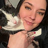 Oreo joined the competition — help win amazing prizes! person, cat, black_and_white_cat, smiling, face, closeup, portrait, indoor, human_hand, ring, nail_polish, pet, cuddling, affection, animal, fur, eyes, whiskers, warm_light, cozy