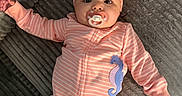 Aleya is registered to the contest to win money with this photo: baby, infant, pink_onesie, headwrap, pacifier, seahorse_patch, lying_down, textured_surface, cute, child, portrait, soft_lighting, indoors, clothing, baby_fashion, sleepwear, adorable, young_child, headwear, cozy