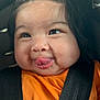 baby, face, tongue, orange_shirt, car_seat, black_straps, child, cute, chubby_cheeks, expression, infant, young_child, portrait, smile, closeup, seatbelt, safety, indoors, hair_tie, person