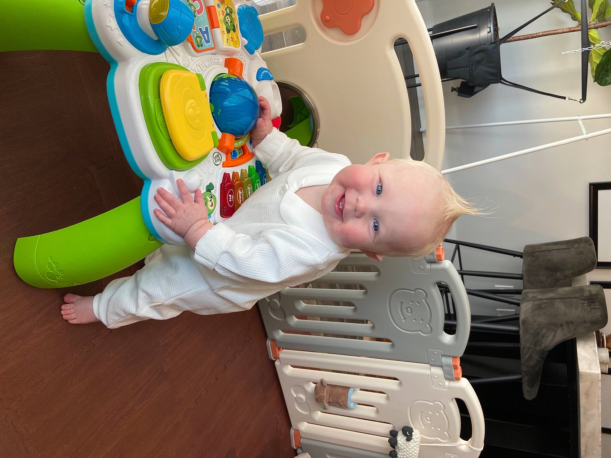 Bear is registered to the contest to win money with this photo: animation, baby, baby_products, baby_toddler_clothing, baby_toys, child, flooring, flowerpot, fun, houseplant, joy, machine, person, plant, plastic, play, room, smile, toddler, toy