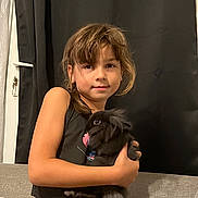 Louane a rejoint le concours — aidez-le/la à gagner de superbes lots ! animal, arm, black_rabbit, casual_clothing, child, comfort, couch, cozy, curtain, face, furniture, girl, hair, home, indoor, pet, portrait, rabbit, smile, toddler