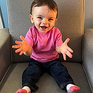 Cadence joined the competition — help win amazing prizes! child, toddler, smiling, happy, sitting, armchair, pink_shirt, jeans, socks, indoor, portrait, cute, hands, face, person, baby, furniture, home, casual_clothing, young_child