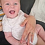 Layton is registered to the contest to win money with this photo: adult_hand, baby, blanket, child, couch, cute, expression, face, fingers, hand, happy, holding, indoor, infant, onesie, person, portrait, skin, smiling, star_pattern