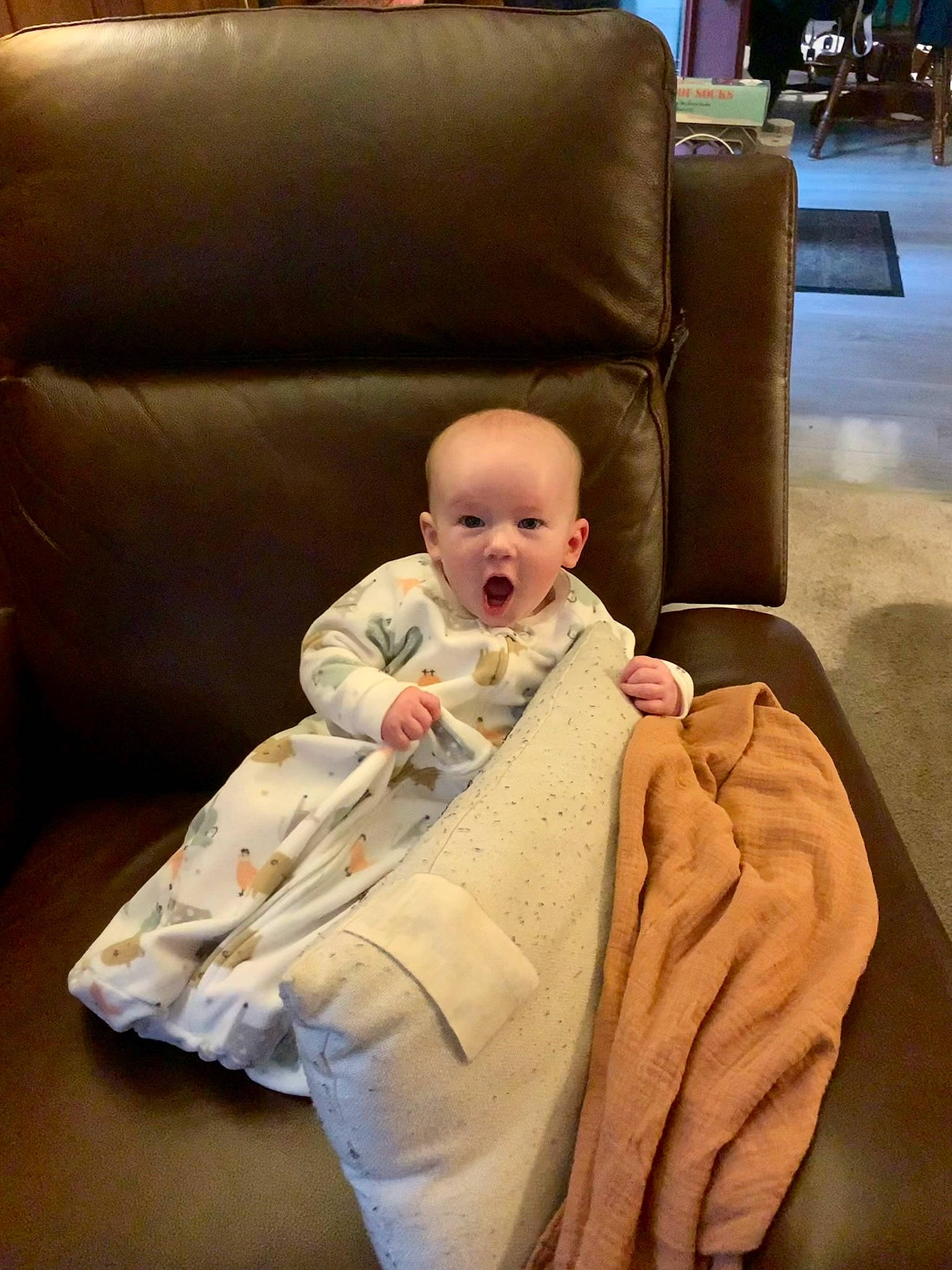 Leo joined the competition — help win amazing prizes! baby, baby_products, baby_toddler_clothing, cheek, child, comfort, couch, flooring, hardwood, lap, living_room, person, room, sitting, sleeper_chair, sofa_bed, studio_couch, surprise, throw_pillow, toddler