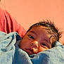 Maddox joined the competition — help win amazing prizes! baby, newborn, blanket, blue_blanket, face, eyes, hair, person, infant, skin, portrait, indoors, child, cute, wrapped, cozy, warm_colors, soft_texture, human, caring