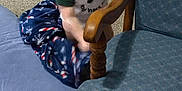 Malcolm is registered to the contest to win money with this photo: toddler, child, pacifier, blanket, carpet, toy, chair, wooden_furniture, indoor, blue, green, plush, baby_clothing, infant, person, candid, blurred, grip, playtime, home