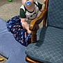 toddler, child, pacifier, blanket, carpet, toy, chair, wooden_furniture, indoor, blue, green, plush, baby_clothing, infant, person, candid, blurred, grip, playtime, home
