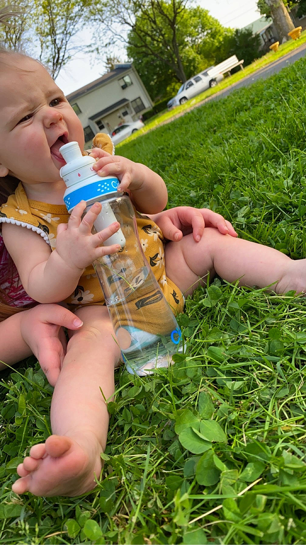 Emberly joined the competition — help win amazing prizes! baby, baby_bottle, drinkware, finger, grass, green, groundcover, hand, happy, human_leg, leisure, nail, people_in_nature, person, plant, plastic_bottle, summer, thigh, thumb, toddler
