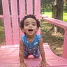 Camila joined the competition — help win amazing prizes! toddler, child, curly_hair, blue_outfit, hearts_pattern, pink_chair, wooden_chair, outdoor, park, grass, tree, playful, smiling, happy, crawling, sunlight, daytime, nature, person, cute