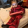 baby, child, curly_hair, cushion, digital_device, focused, hair_bows, indoors, playroom, portrait, red_outfit, relaxed, sitting, tablet, teddy_bear, toddler, toy, toy_truck, velvet, winnie_the_pooh