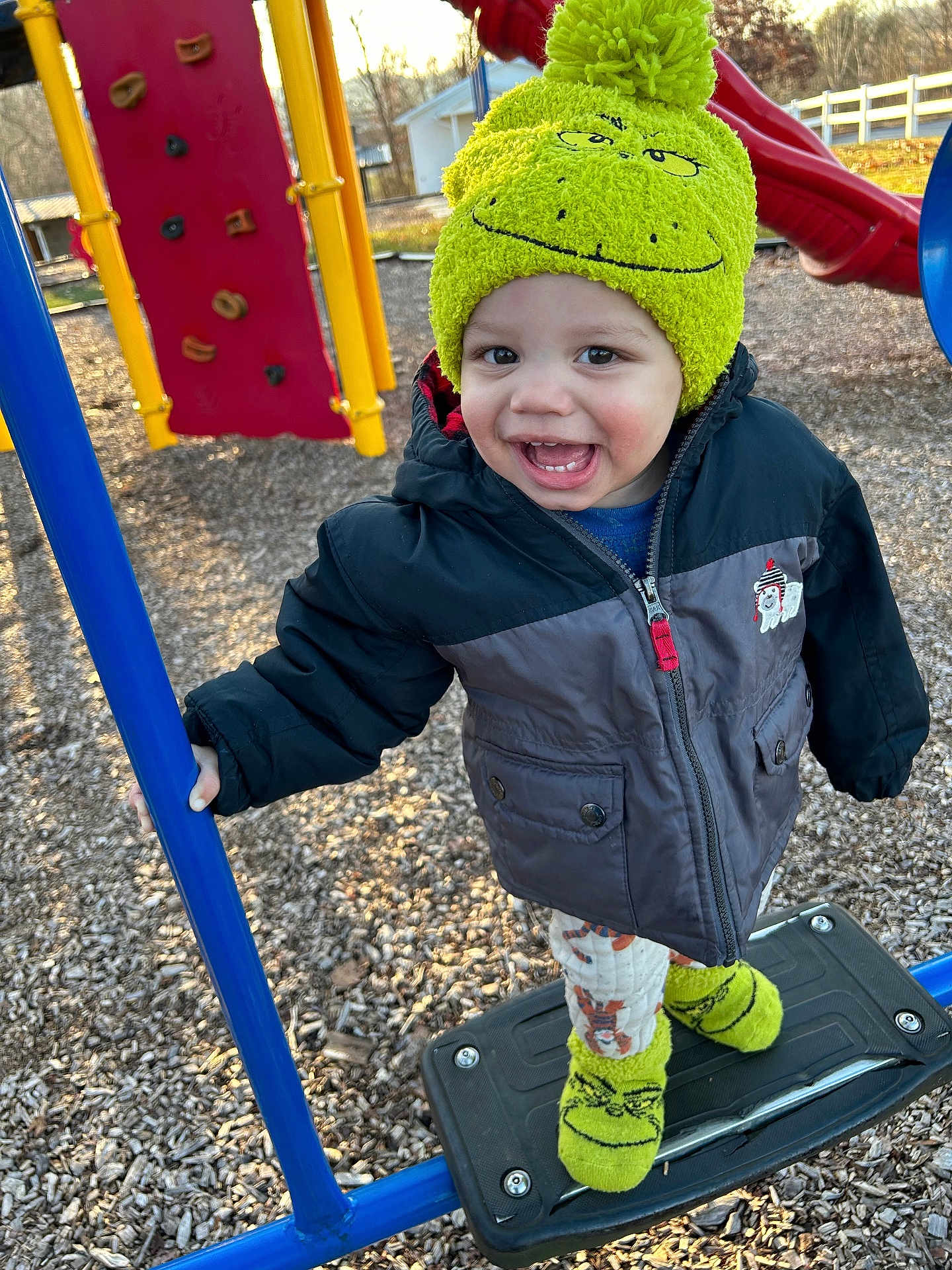 Kashton is registered to the contest to win money with this photo: baby, ball, clothing, coat, face, grass, hat, head, jacket, nature, outdoorplayarea, outdoors, park, person, photography, plant, playarea, portrait, sport, tennis