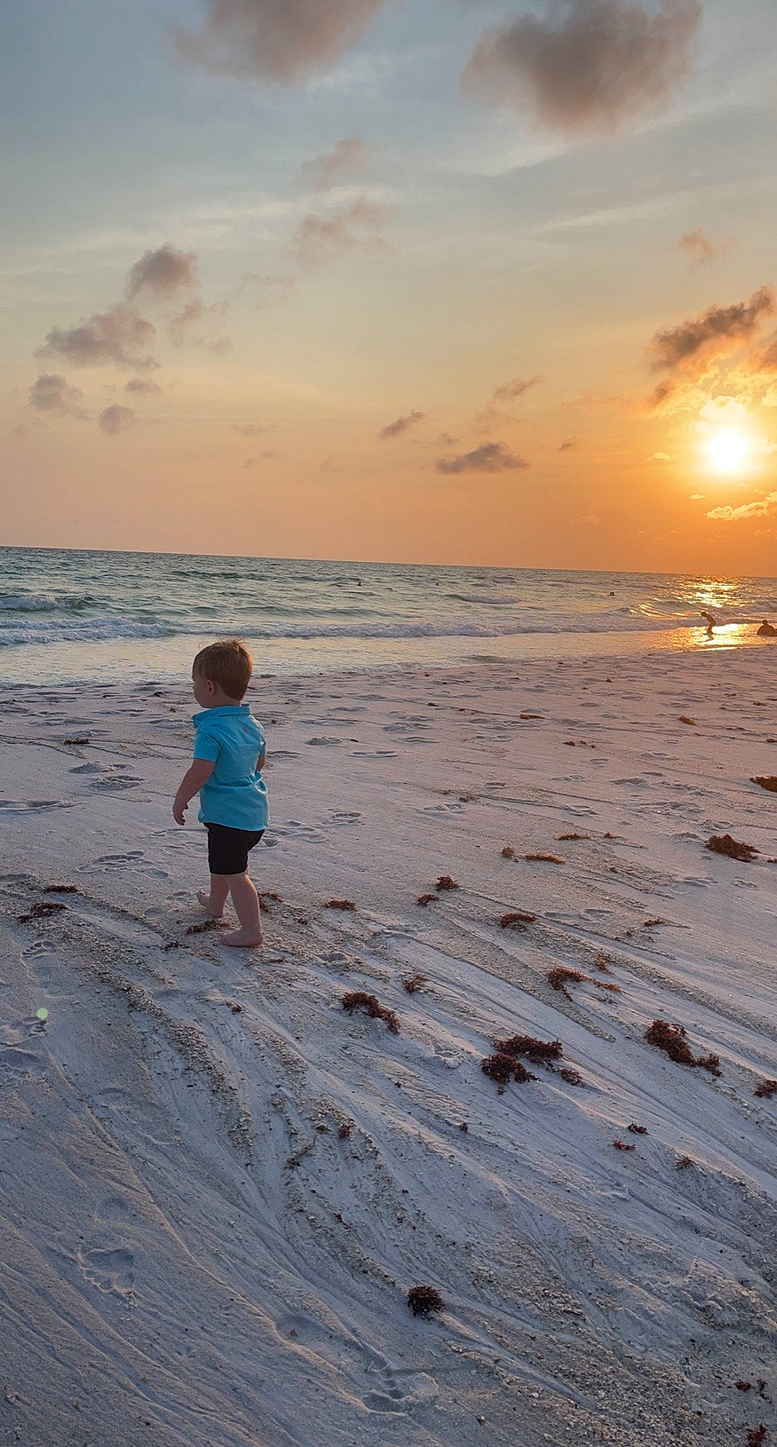 Kailor joined the competition — help win amazing prizes! beach, calm, cloud, coastal_and_oceanic_landforms, dusk, happy, horizon, light, nature, people_in_nature, people_on_beach, person, shorts, sky, summer, sunlight, sunrise, toddler, water, wind_wave
