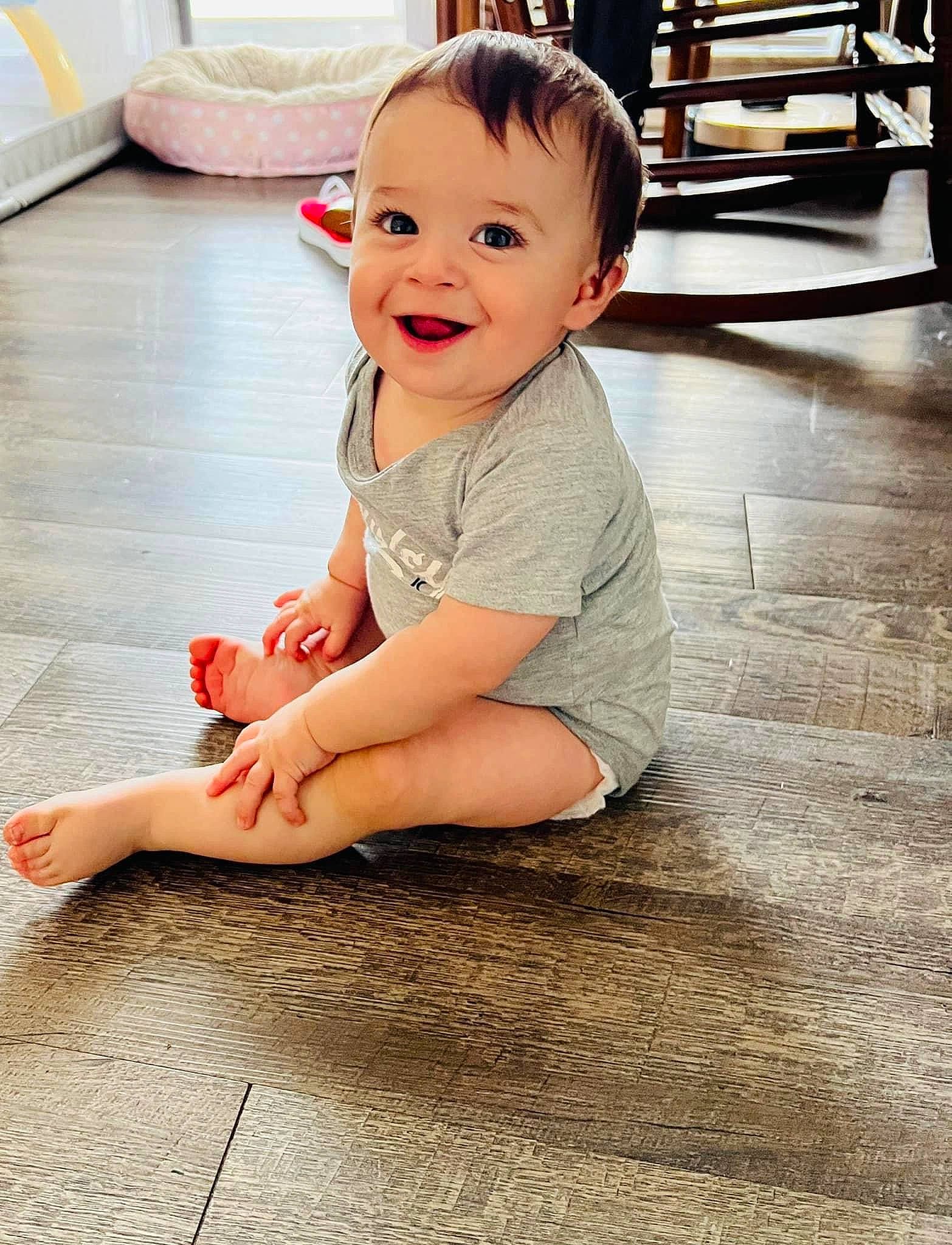 Flynn is registered to the contest to win money with this photo: baby, baby_toddler_clothing, cheek, chin, eye, face, floor, flooring, happy, head, iris, joy, leg, nose, person, skin, sleeve, smile, standing, toddler