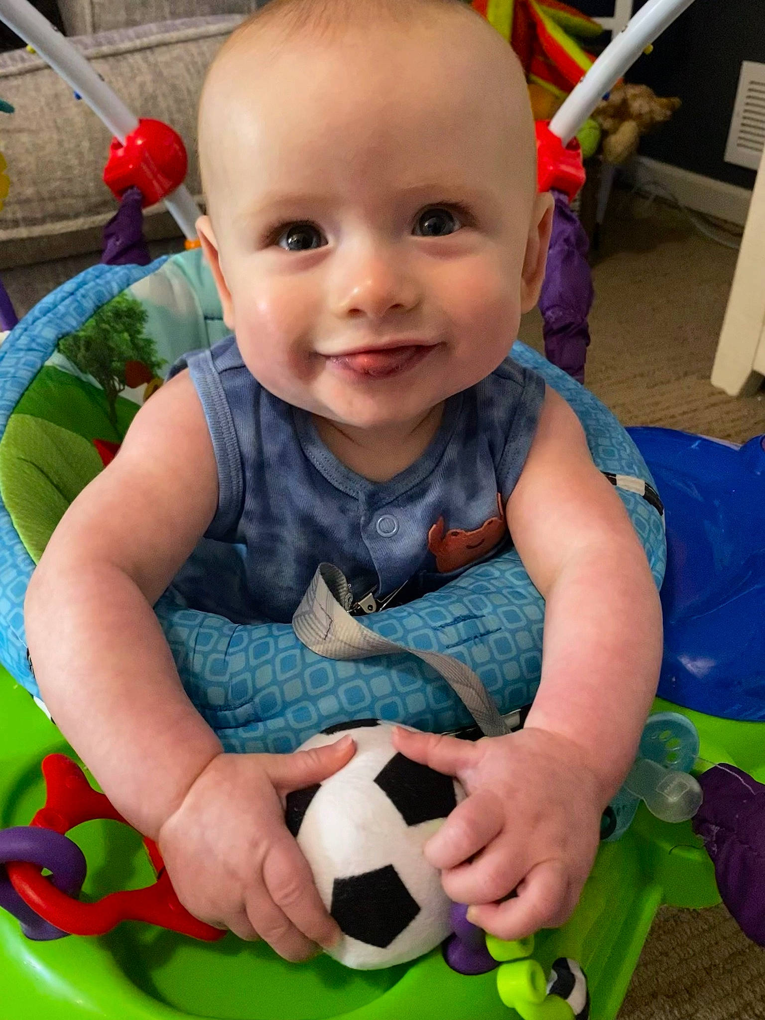 Auggie joined the competition — help win amazing prizes! arm, baby, baby_playing_with_toys, baby_toddler_clothing, black, blue, cheek, eye, facial_expression, green, happy, human_body, joy, person, photograph, product, skin, smile, sports_equipment, textile