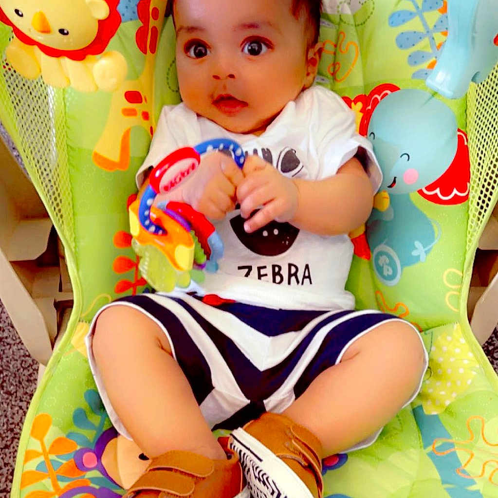 Aaron joined the competition — help win amazing prizes! baby, chair, clothing, cushion, face, footwear, furniture, glove, head, homedecor, person, photography, portrait, sandal, shoe, shorts, sitting, sneaker, t_shirt, toy