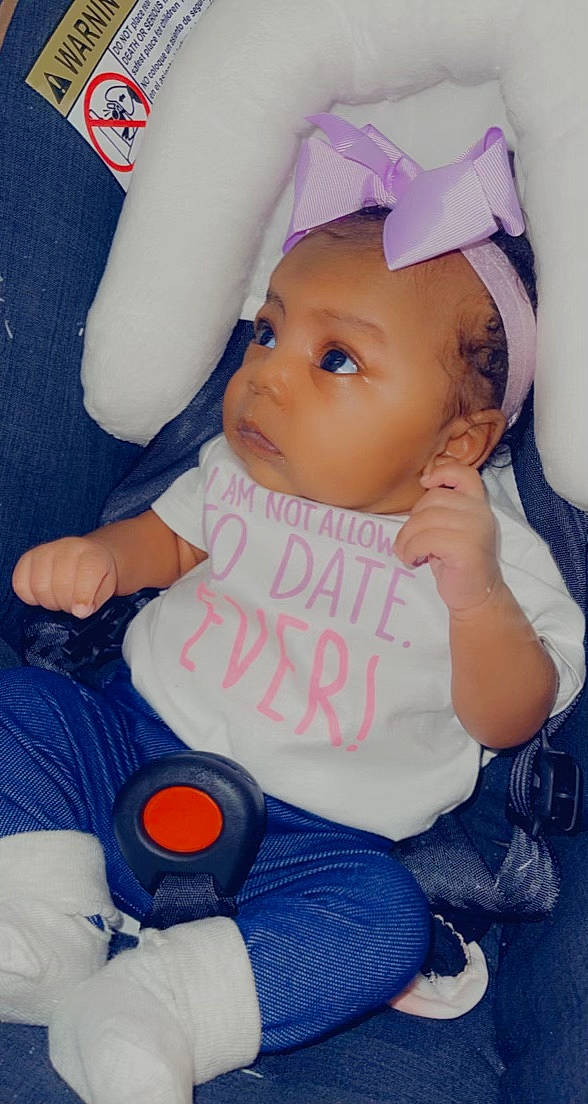 Meriah is registered to the contest to win money with this photo: arm, baby, baby_toddler_clothing, cheek, child, comfort, finger, hand, happy, hat, head, headwear, lip, mouth, organ, people, person, pink, skin, textile