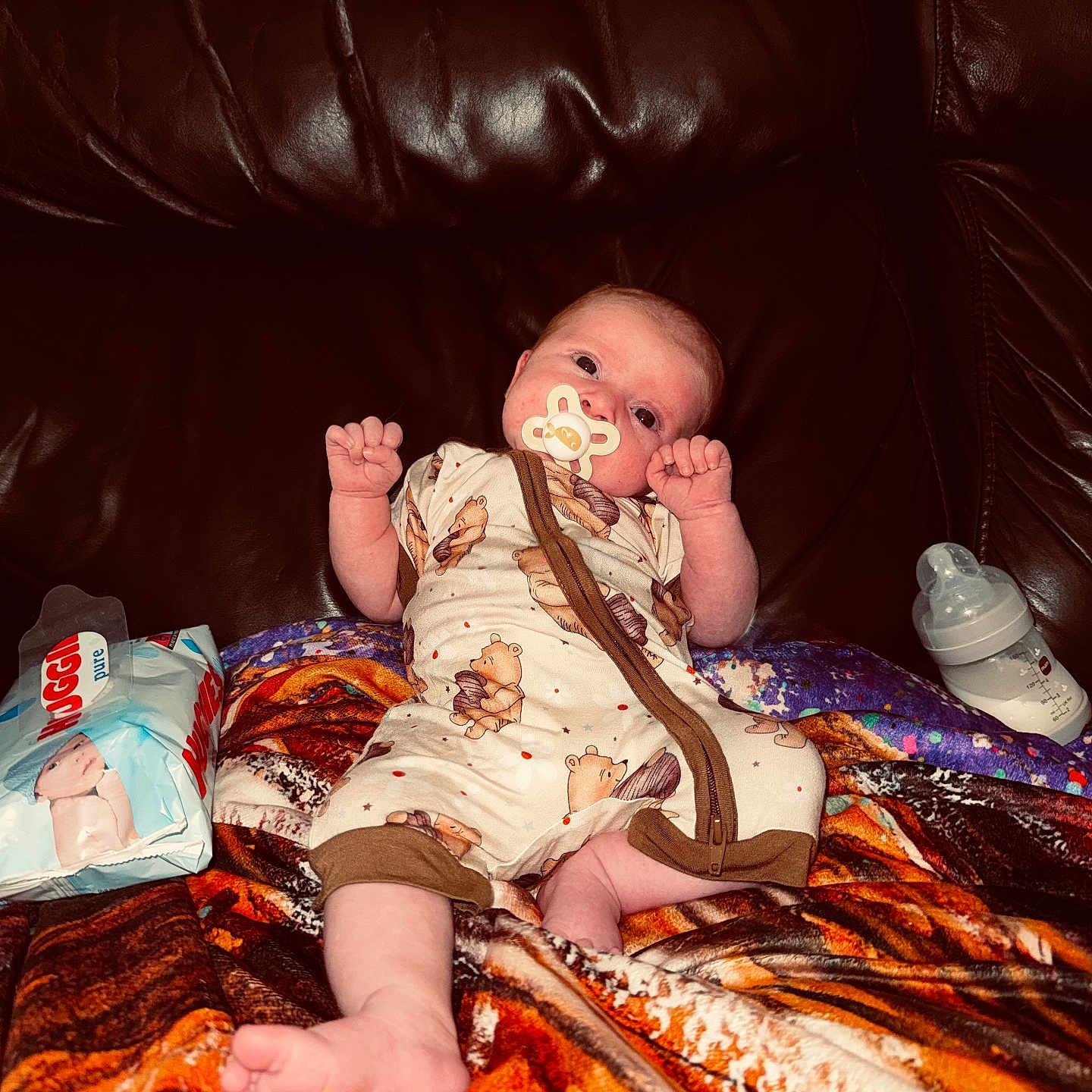 Rayla-Mae joined the competition — help win amazing prizes! baby, baby_bottle, baby_wipes, blanket, child, clothing, comfort, couch, cute, face, indoors, infant, leather, lying_down, pacifier, person, resting, small, soft, wearing