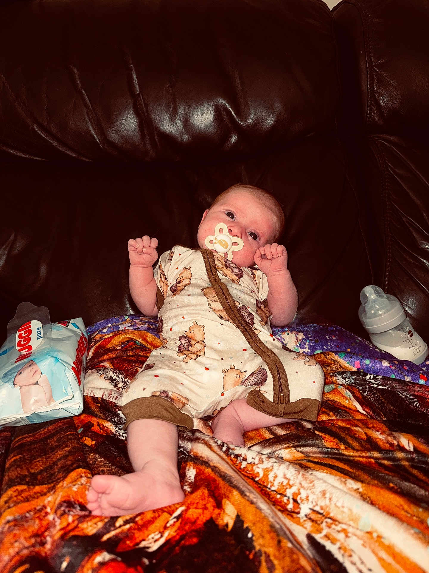 Rayla-Mae joined the competition — help win amazing prizes! baby, pacifier, blanket, couch, leather, baby_bottle, baby_wipes, infant, clothing, cute, person, lying_down, indoors, child, comfort, soft, resting, face, small, wearing