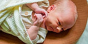 Waylon is registered to the contest to win money with this photo: baby, newborn, blanket, infant, sleeping, soft_texture, cushion, closeup, wrapped, peaceful, cute, child, skin, head, hand, indoors, portrait, resting, cozy, serene