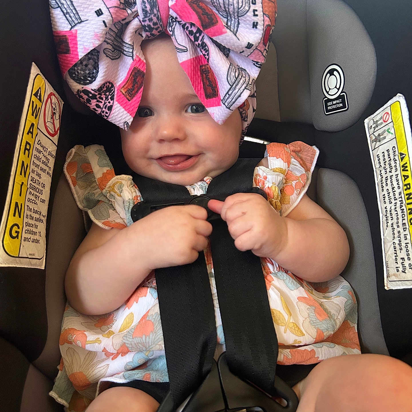 Nova Sage is registered to the contest to win money with this photo: accessories, baby, belt, car, car_interior, carseat, clothing, cushion, dress, face, happy, hat, head, homedecor, person, photography, portrait, smile, transportation, vehicle