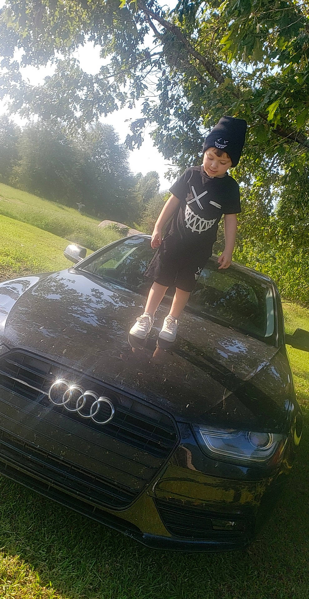 Cole joined the competition — help win amazing prizes! alloy_wheel, automotive_design, automotive_exterior, automotive_lighting, automotive_tire, bumper, car, fender, hat, headlamp, headwear, hood, motor_vehicle, person, personal_luxury_car, rim, shorts, sky, tree, vehicle