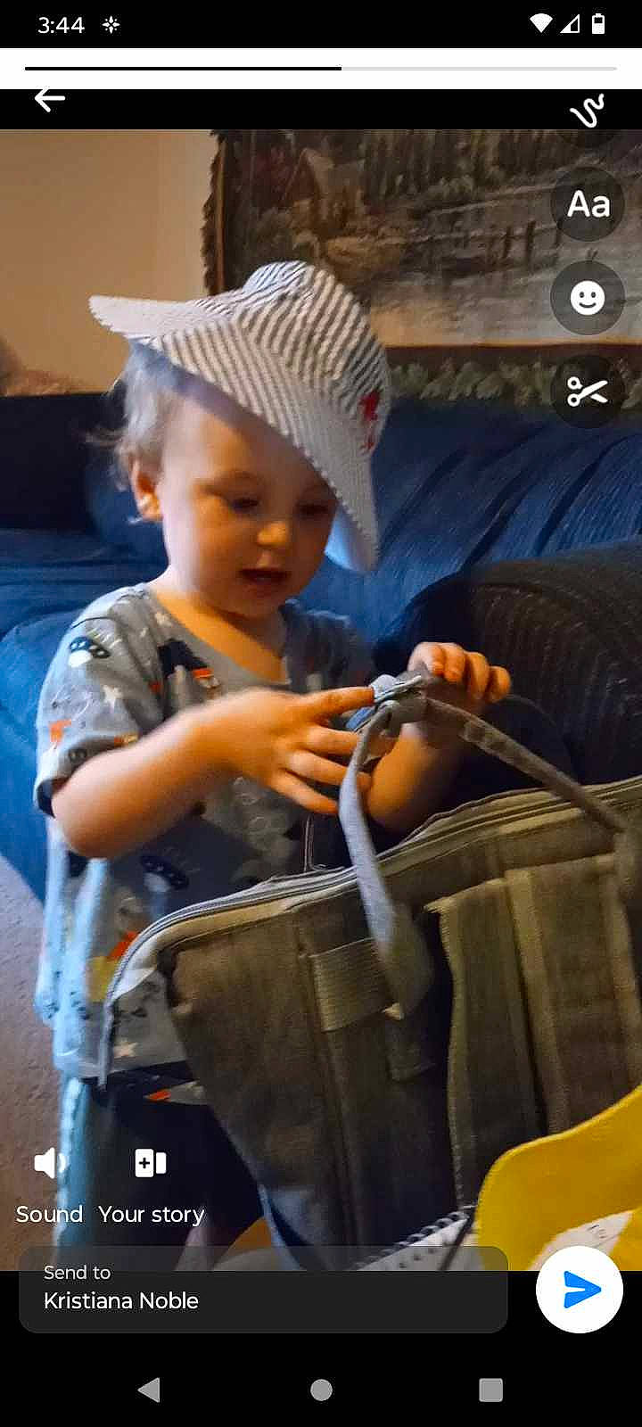 Andrew is registered to the contest to win money with this photo: baby, bag, cap, child, fashion_accessory, hat, headwear, human, luggage_and_bags, person, sitting, toddler, travel, wheel